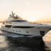 Luxury yacht cruising GBA waters at golden hour