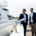 Yacht asset management discussion beside a luxury yacht