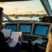 Yacht crew reviewing route and documents before a northbound voyage