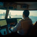 Yacht captain navigating with monitoring systems at sea