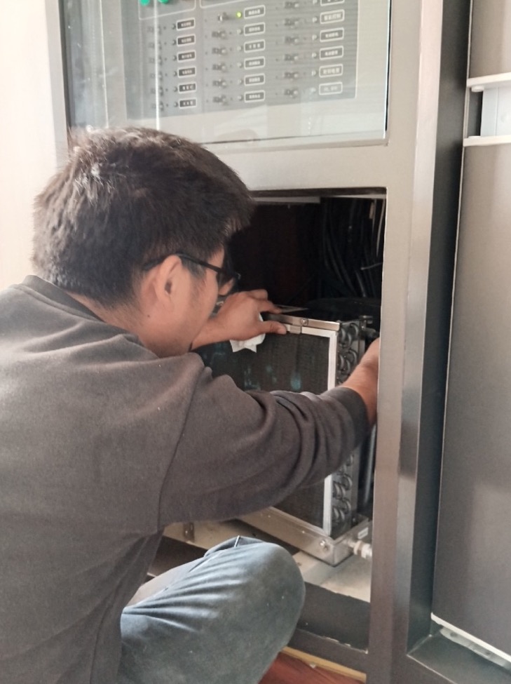 Technician inspecting onboard air conditioning equipment